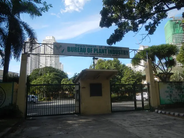 The image shows the entrance to the Bureau of Plant Industry in Manila, with an arch with text on...