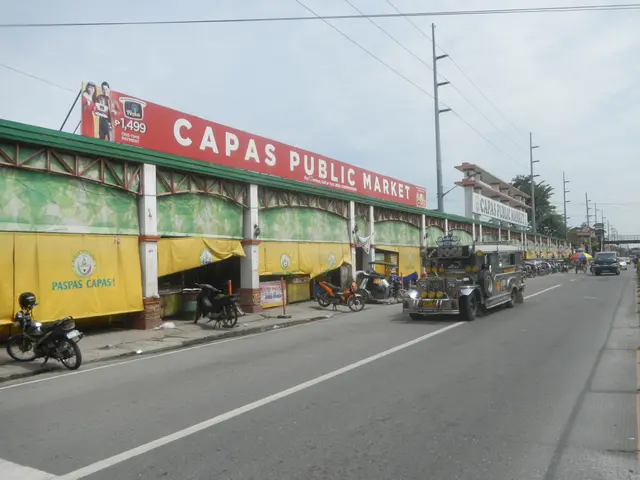 The image shows a bustling city street with vehicles on the road, a footpath on the right side,...