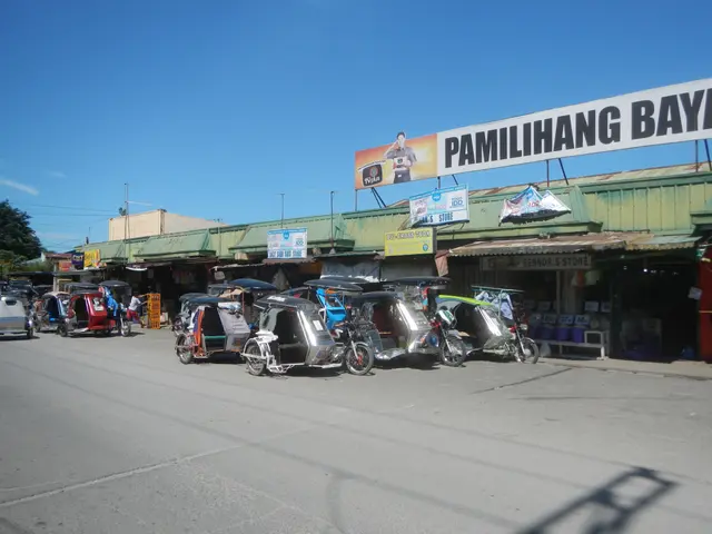 The image shows a bustling street in Manila, Philippines, with a variety of vehicles on the road,...