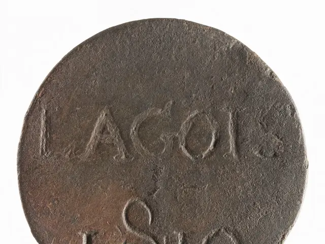 The image shows a silver coin with the word "Lagos" written on it against a white background.