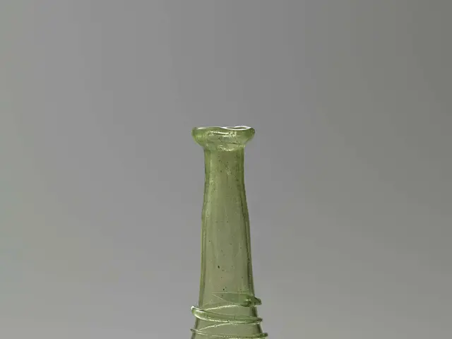 The image shows a green glass bottle with a stopper, which is believed to be a wine decanter. It...