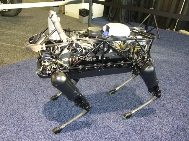 The image shows a robot sitting on top of a blue carpeted floor, with a machine in the center and a...