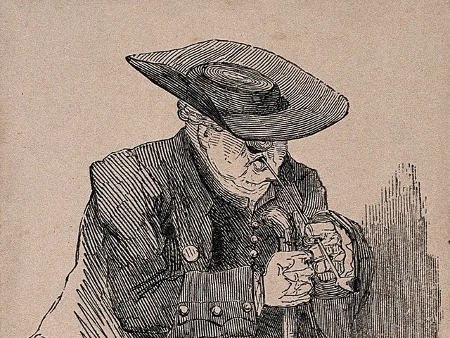 The image shows an old man wearing a hat, sitting on a chair and holding something in his hand. At...