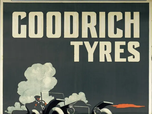 The image shows a poster advertising Goodrich Tyres, featuring a car with a person sitting in it....