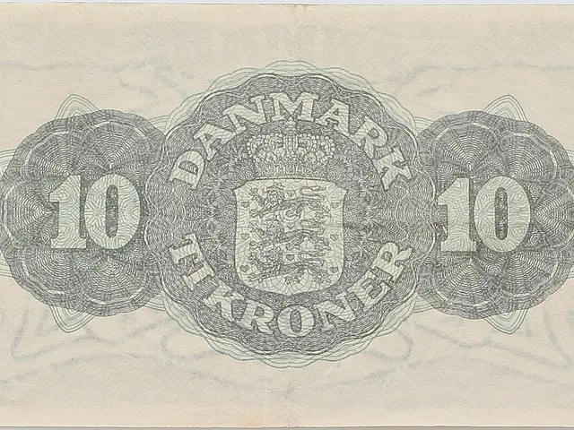 The image shows an old 10 Kroner banknote from Denmark with a coat of arms on it. The paper has...