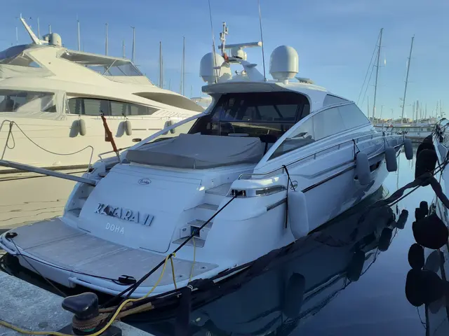 The image shows a fairline squadron 62 motor yacht docked at a dock with other boats in the...