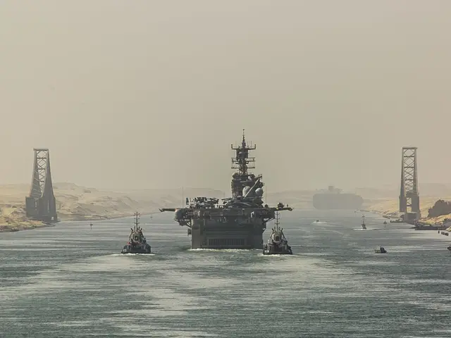 The image shows an aircraft carrier, the USS George H W Bush CVN-68, transiting the Arabian Sea....