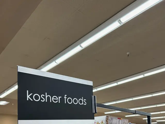 The image shows a store filled with lots of different types of kosher foods, including bottles,...