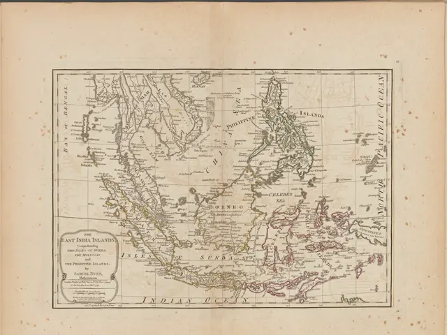 The image shows an old book with a map of the Philippines and Southeast Asia on it. The map is...