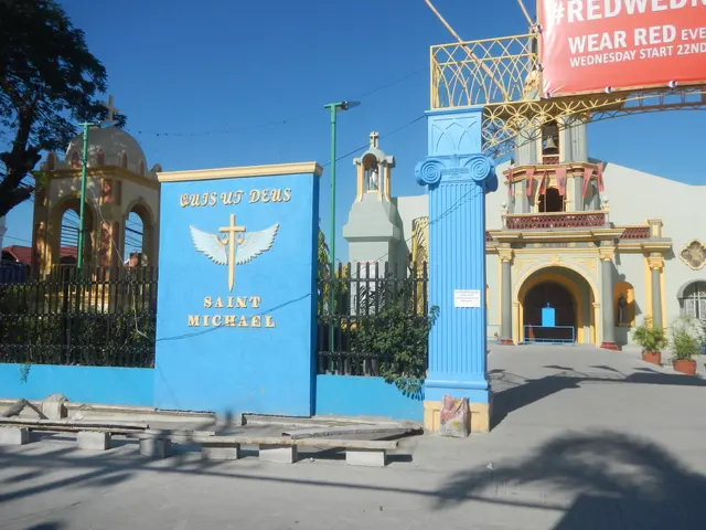 The image shows the entrance to St. Michael's Church in Cebu City, Philippines. It features a blue...