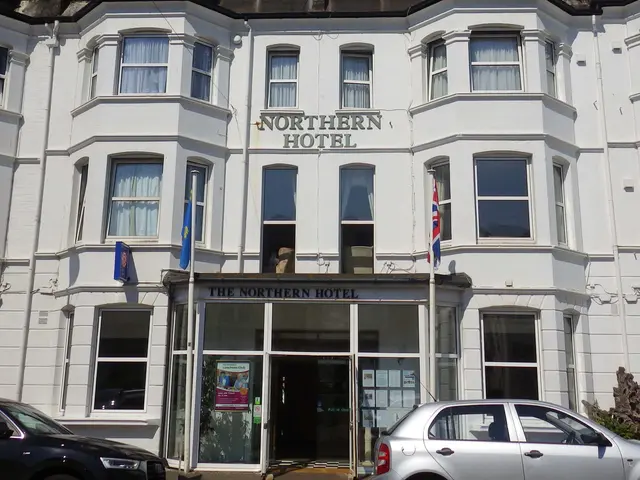 The image shows the Northern Hotel in Brighton, England. It is a large white building with glass...