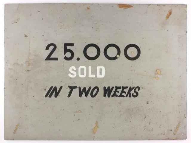 The image shows a white background with a sign that reads "25,000 sold in two weeks" in bold black...