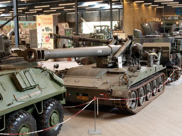 The image shows a group of military vehicles parked inside of a building, with a person standing...