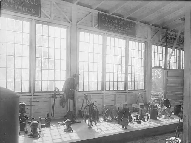 The image shows a black and white photo of a large room filled with lots of tools, including...