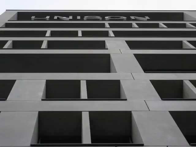 In this picture we can see a building with a name on it.