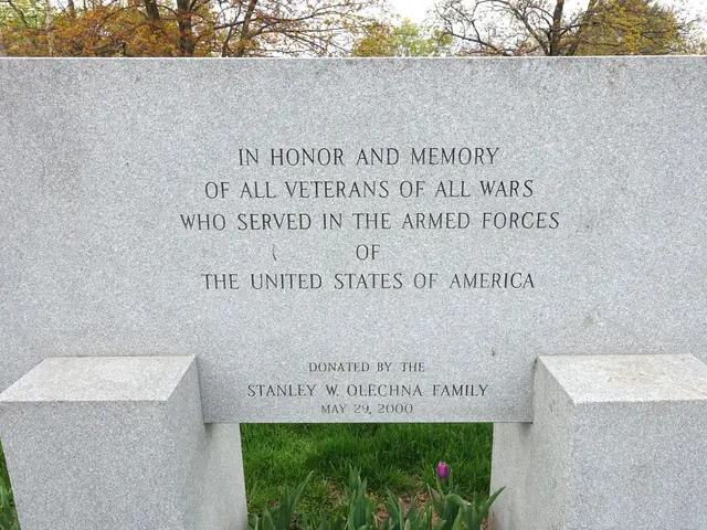 The image shows a memorial stone with the words "In honor and memory of all veterans of all wars...