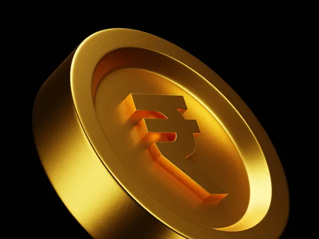 The image shows a gold coin with the Indian rupee symbol on it against a white background.
