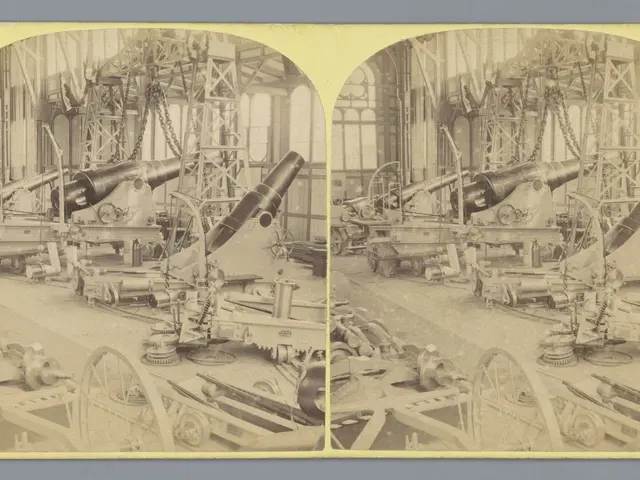 The image shows an old black and white photo of a factory with a large cannon in the center....